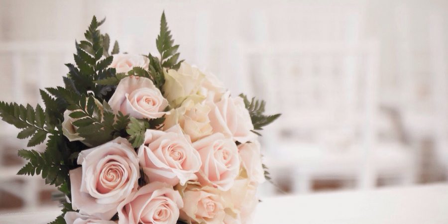 bouquet of roses on table at wedding 683866307 5a8207778023b90037a1f946 900x450 - How Beautiful Flowers Can Make Your Wedding More Unforgettable